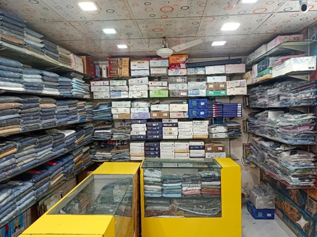 Bright interior with jeans, boxed shirts, and yellow display counters